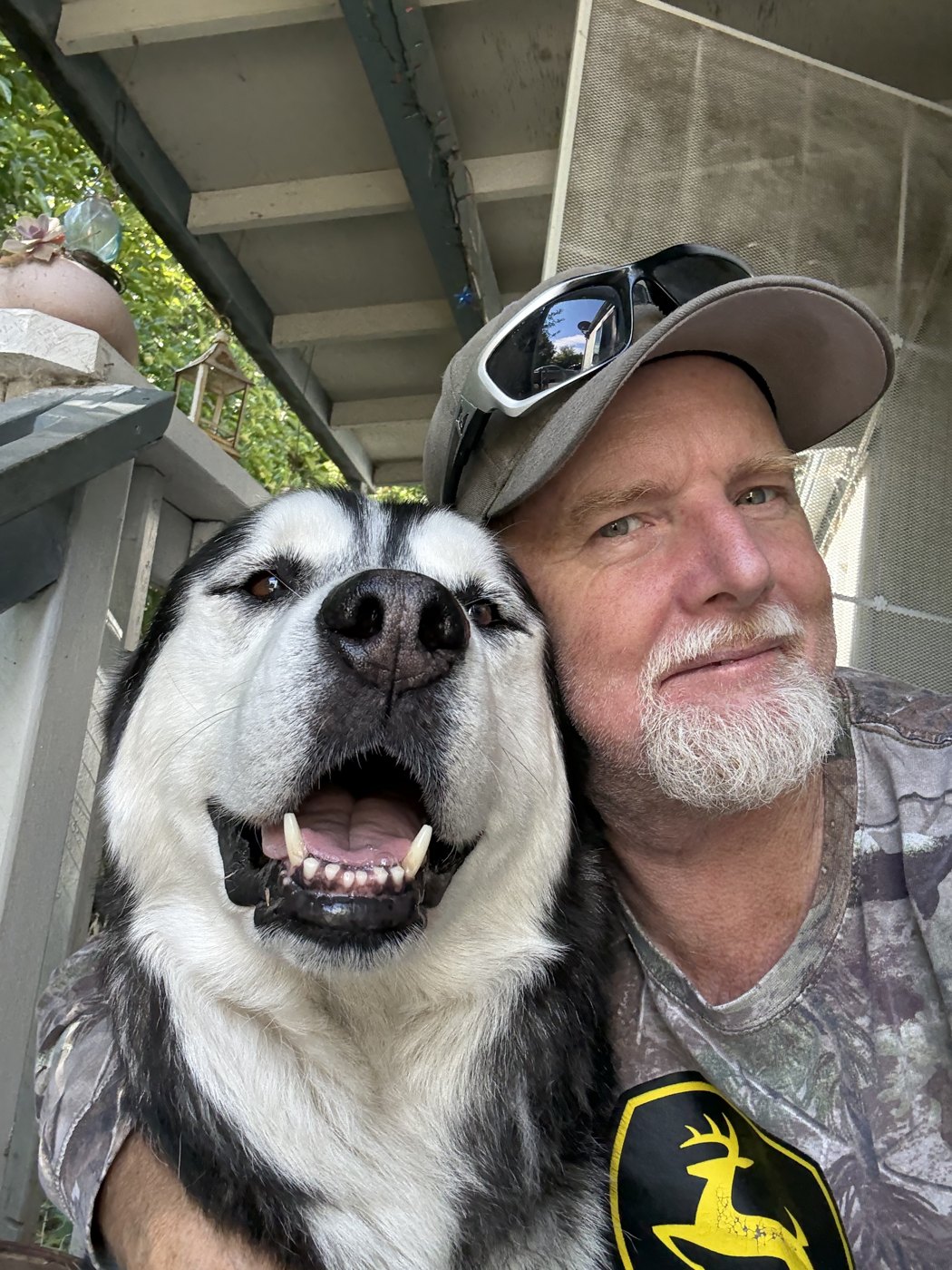 Thomas Shulte, owner of Twisted Oaks Repair, with his dog